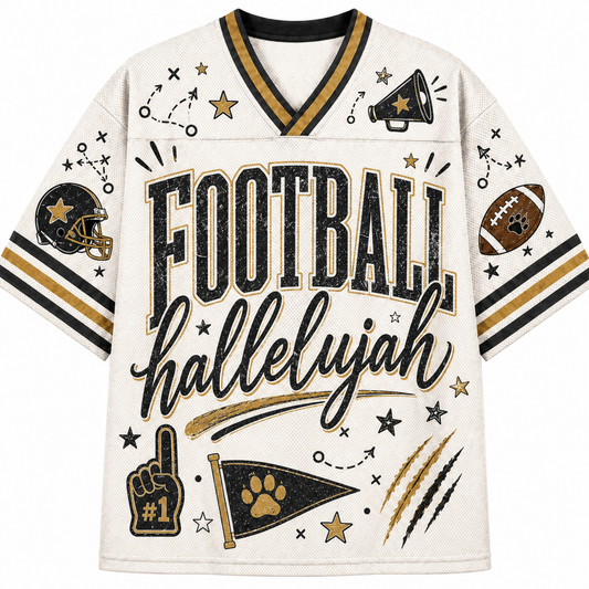 A cream-colored football jersey with black and gold accents, featuring the text 'FOOTBALL hallelujah' across the front, surrounded by football-themed graphics including a helmet, paw print, stars, and a megaphone.
