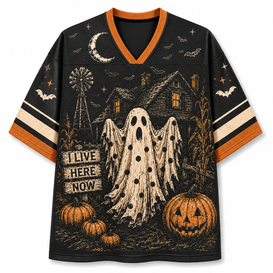 A black V-neck short-sleeve jersey-style shirt with orange trim and a Halloween graphic print featuring a ghost, haunted house, pumpkins, bats, stars, and a moon on a white background.