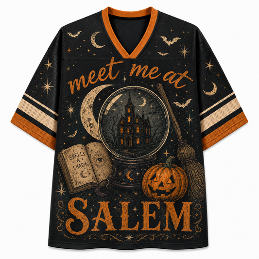 Front view of the black gothic varsity jersey showcasing 'meet me at SALEM' lettering above a crystal ball with a haunted manor, spellbook, and witch broomstick.