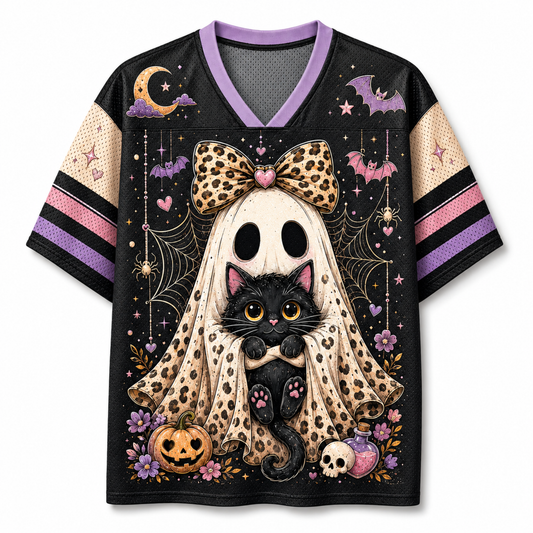 A short-sleeve V-neck jersey-style shirt with a Halloween graphic print. The design features a black cat in front of a large ghost with a leopard-print bow, surrounded by bats, a crescent moon, spiderwebs, pumpkins, and a skull.
