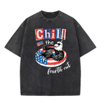 ChaoticClub Chill The Fourth Out Eagle Washed T-Shirt, vintage oversized graphic tee featuring a cool bald eagle in sunglasses and a party hat lounging in a patriotic pool float with a popsicle and an American flag with funny text on premium washed cotton fabric