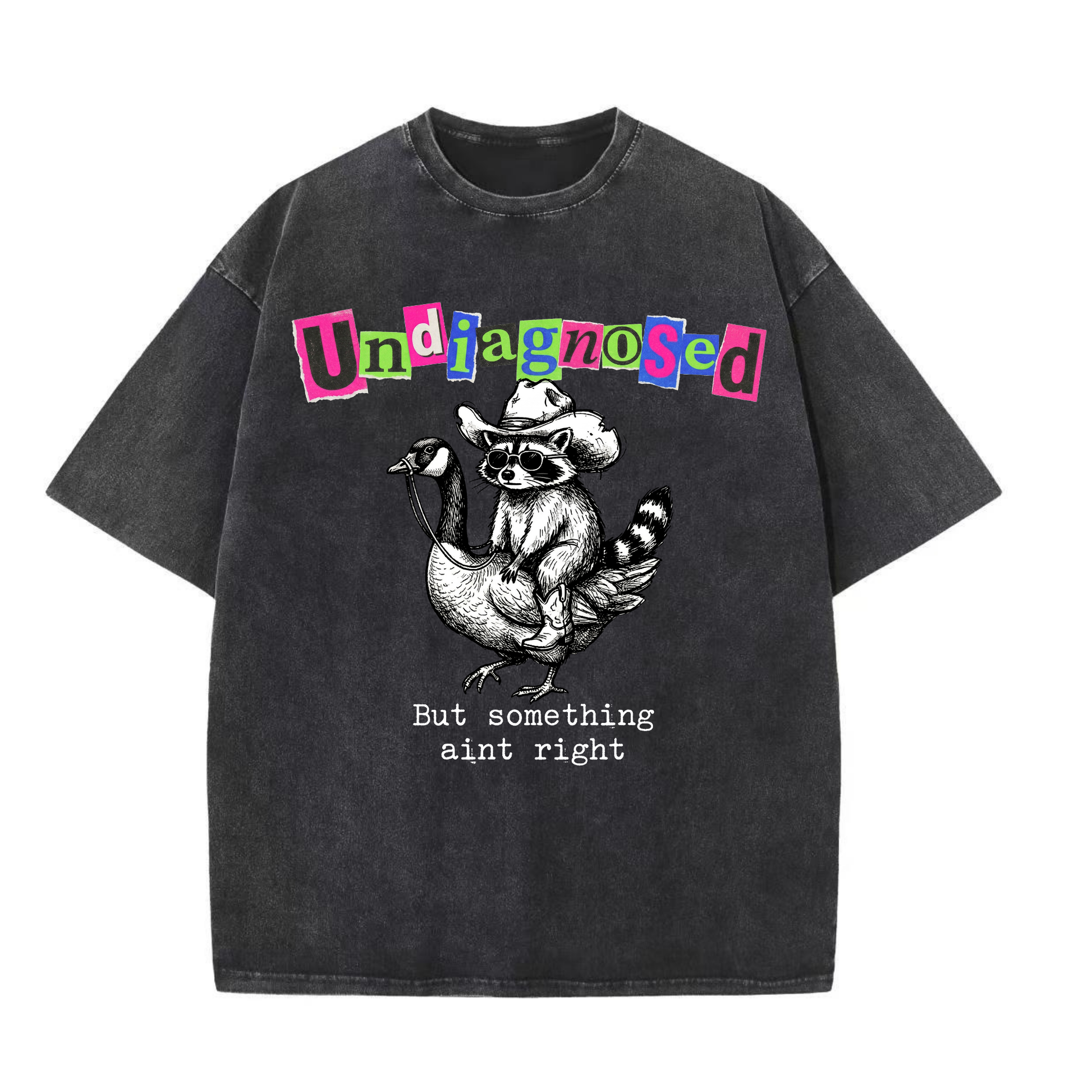 ChaoticClub Undiagnosed Raccoon Washed T-Shirt, vintage oversized graphic tee featuring a cowboy raccoon riding a goose with funny sarcastic text on premium charcoal washed cotton fabric
