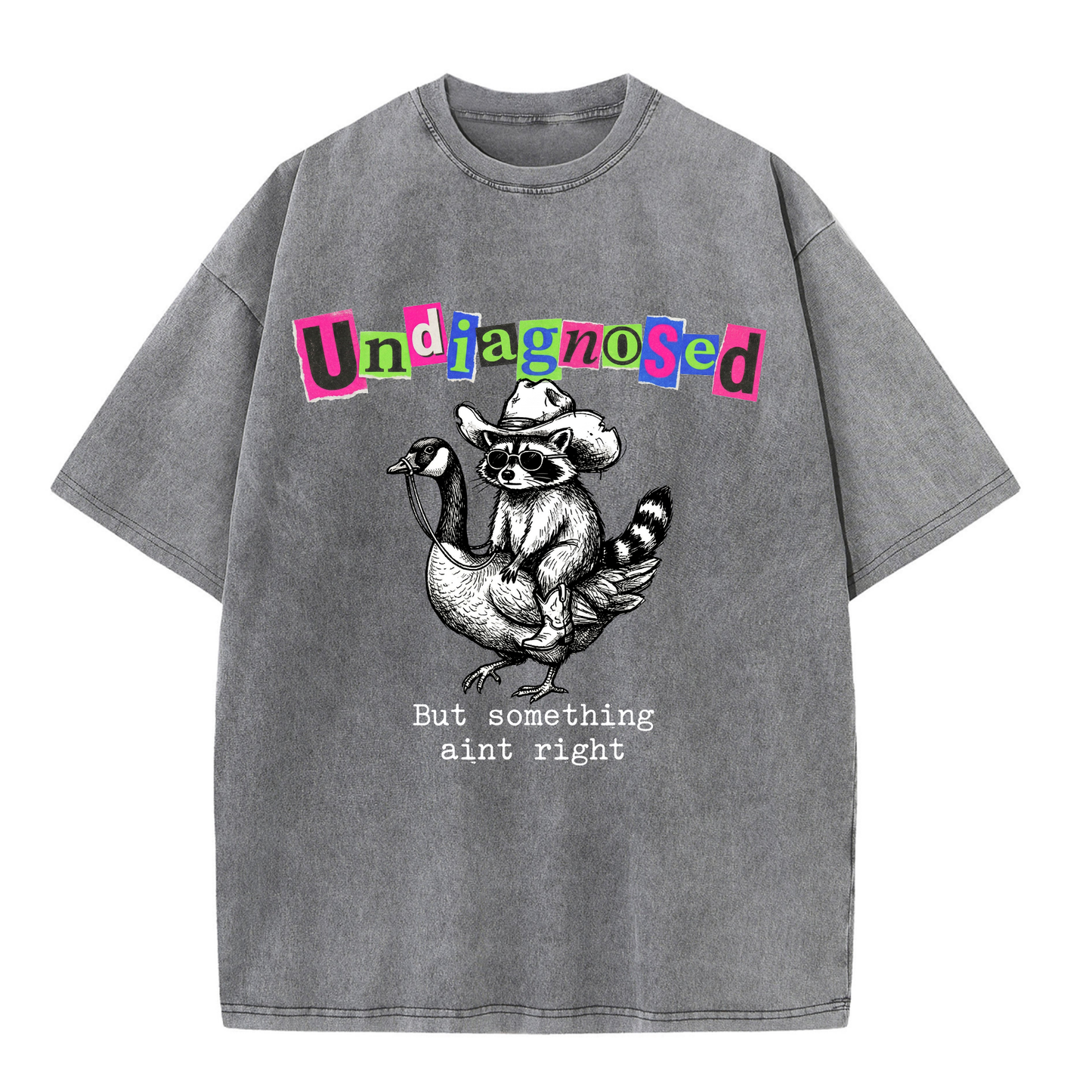 ChaoticClub Undiagnosed Raccoon Washed T-Shirt, vintage oversized graphic tee featuring a cowboy raccoon riding a goose with funny sarcastic text on premium charcoal washed cotton fabric