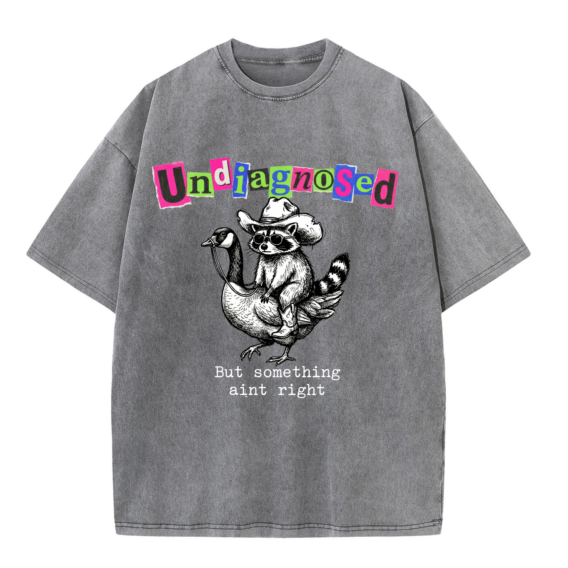 ChaoticClub Undiagnosed Raccoon Washed T-Shirt, vintage oversized graphic tee featuring a cowboy raccoon riding a goose with funny sarcastic text on premium charcoal washed cotton fabric