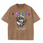 ChaoticClub Undiagnosed Raccoon Washed T-Shirt, vintage oversized graphic tee featuring a cowboy raccoon riding a goose with funny sarcastic text on premium charcoal washed cotton fabric