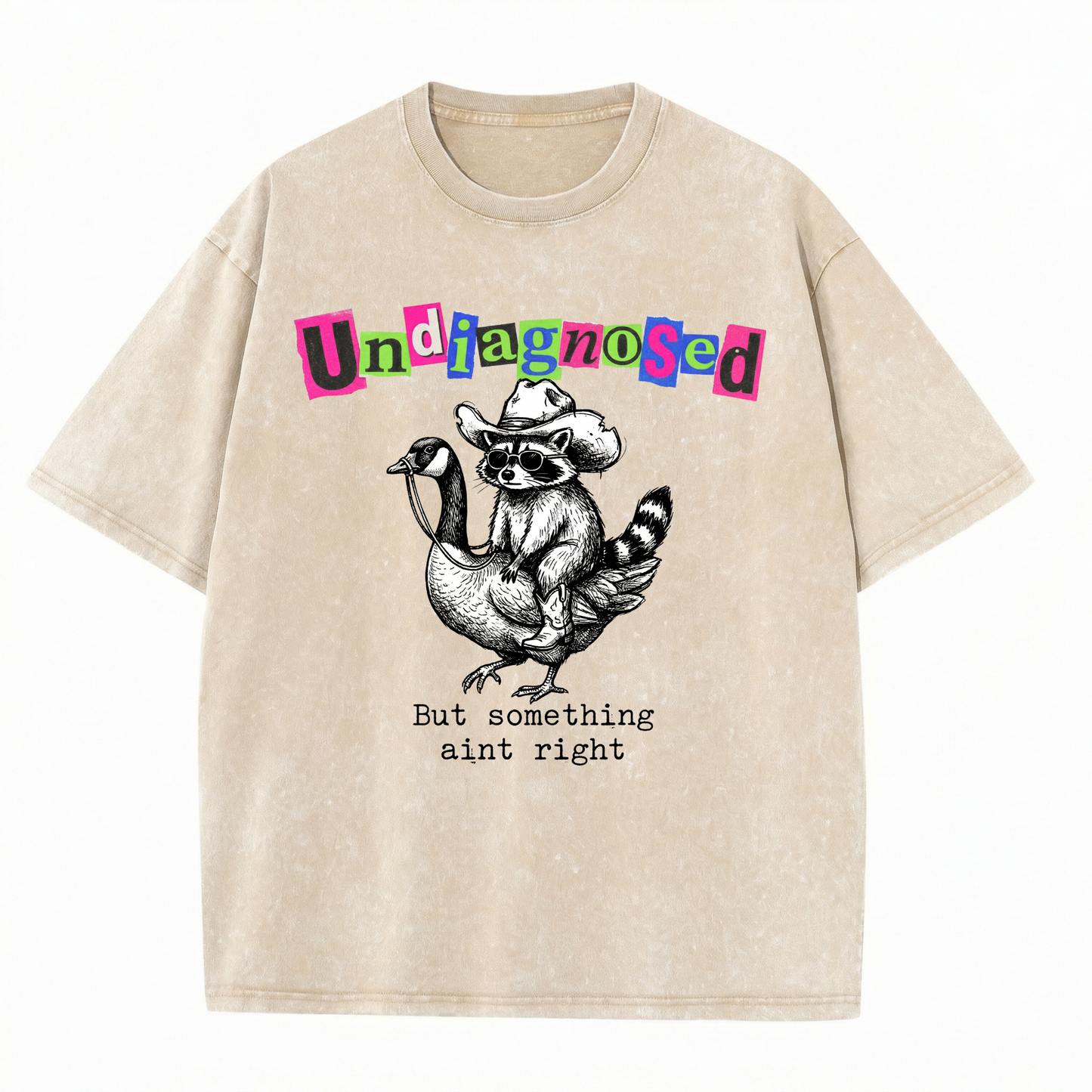 ChaoticClub Undiagnosed Raccoon Washed T-Shirt, vintage oversized graphic tee featuring a cowboy raccoon riding a goose with funny sarcastic text on premium charcoal washed cotton fabric