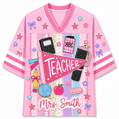 Front view of the pink ChaoticClub Preppy Back To School Teacher Pennant Flag Mesh Jersey, featuring a pink teacher pennant, globe, notebooks, apple, and custom "Mrs. Smith" text.
