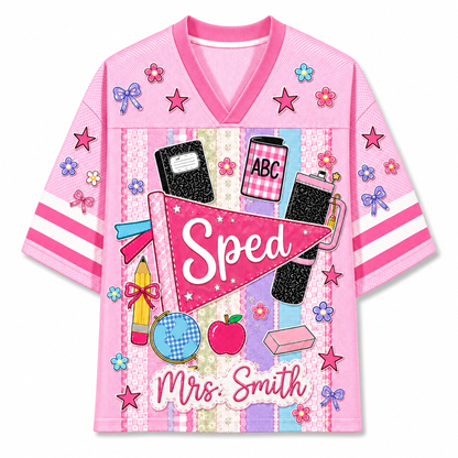 Front view of the pink ChaoticClub Preppy Back To School Teacher Pennant Flag Mesh Jersey, featuring a pink sped pennant, globe, notebooks, apple, and custom "Mrs. Smith" text.