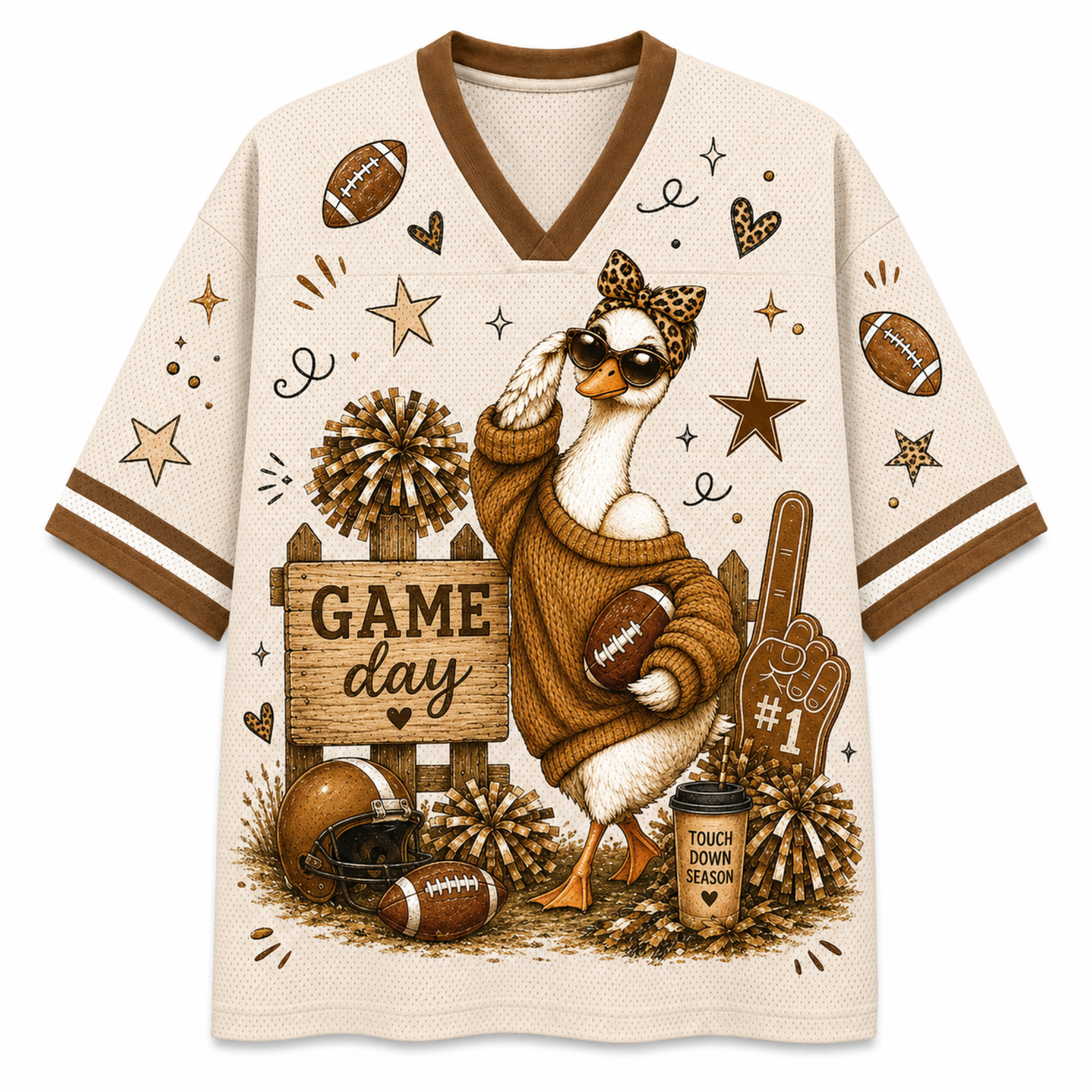 A cream-colored athletic-style V-neck t-shirt with brown trim, featuring a detailed graphic of a duck character wearing sunglasses and a sweater, holding a football, surrounded by footballs, stars, pom-poms, a helmet, a foam finger, and a coffee cup that reads 'TOUCH DOWN SEASON'.