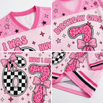 Pink mesh V-neck jersey top with birthday girl number 6 graphics, including leopard print numbers, pink bows, stars, checkered patterns, and text reading 'BIRTHDAY GIRL' and 'NOW I AM 6'.
