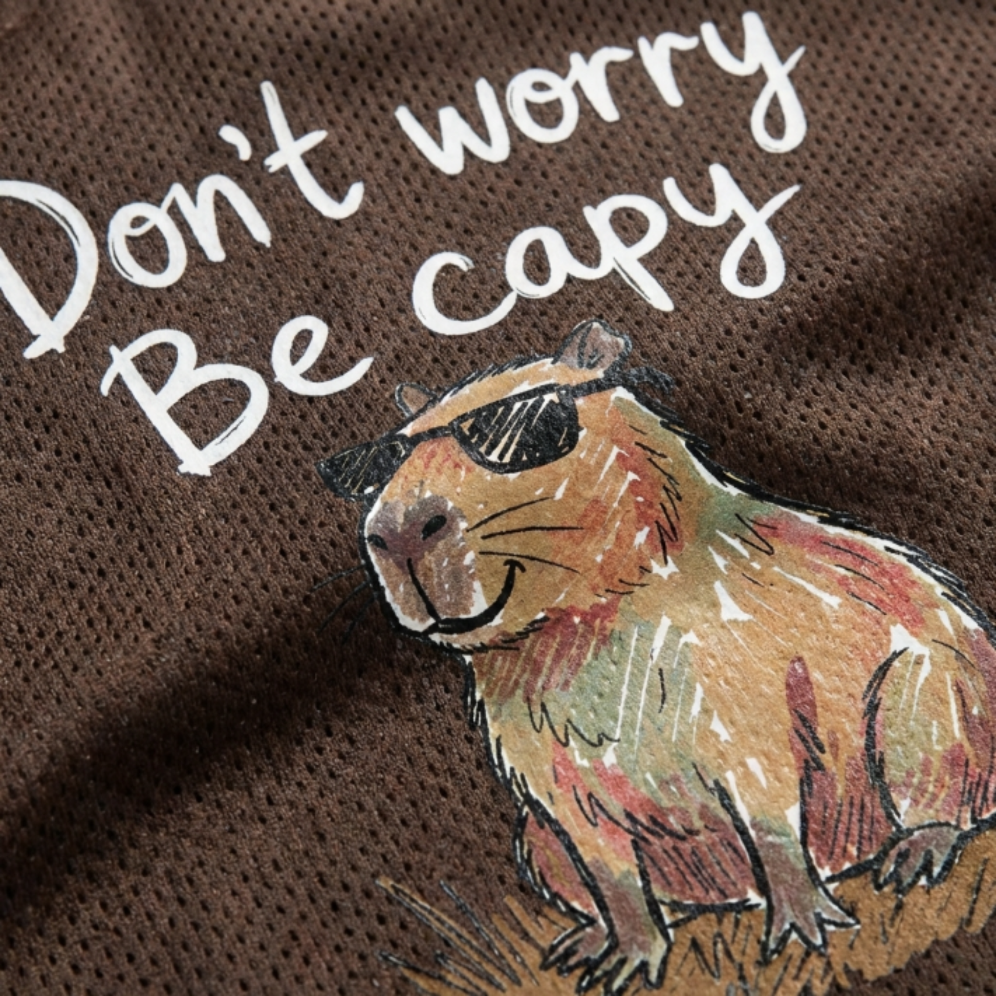 ChaoticClub Don’t Worry Be Capybara Mesh Jersey, vintage athletic oversized jersey on dark brown and tan breathable mesh featuring a chill capybara in sunglasses with "Don't worry Be capy" funny text.