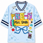 Front view of the light blue ChaoticClub Doodle Back to School Teacher Mesh Jersey, featuring colorful patchwork "PRE-K" text, a large yellow pencil graphic with customizable "Mrs. Smith" name, and small school doodles.