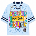 Front view of the light blue ChaoticClub Doodle Back to School Teacher Mesh Jersey, featuring colorful patchwork "SECOND GRADE" text, a large yellow pencil graphic with customizable "Mrs. Smith" name, and small school doodles.