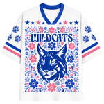 Front view of the white ChaoticClub Floral School Spirit Personalized Mesh Jersey, featuring a large blue Wildcats mascot head surrounded by a symmetrical folk-art floral border in pink and blue, with row of stars below the v-neck collar.