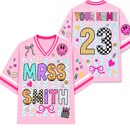 Pink sports jersey with customizable text on a white background