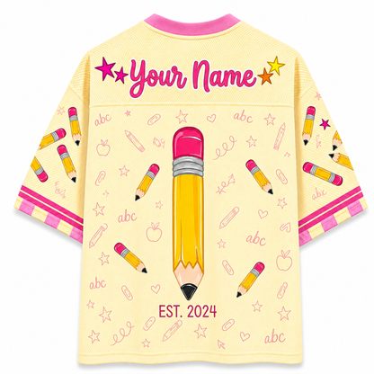 Children's shirt with pencil design and 'Your Name' text on a yellow background