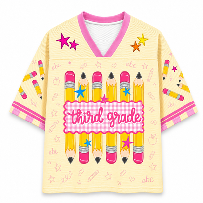Children's shirt with 'third grade' design featuring pencils and stars on a yellow background.