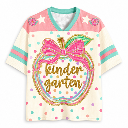 Front view of the ChaoticClub Preppy Back to School Teacher Apple Mesh Jersey, featuring a cute apple graphic with a pink bow, colorful polka dots, and gold glitter "kindergarten" text.