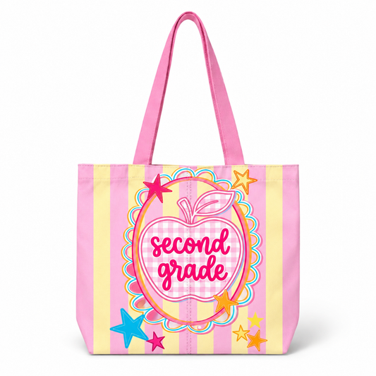 Tote bag with 'second grade' text and apple design on a pink and yellow striped background