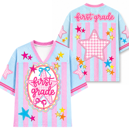 Children's shirt with 'first grade' text and star designs on a light blue background