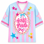 Children's shirt with 'first grade love' text and star designs on a light blue background