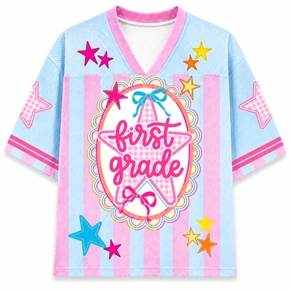 Children's shirt with 'first grade love' text and star designs on a light blue background