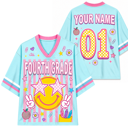 Children's light blue jersey with 'Fourth Grade' and 'Your Name 01' text, colorful graphics on a white background.