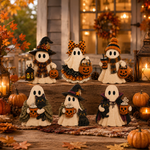 A set of six Halloween ghost figurines decorated with witch hats, bows, scarves, and accessories, arranged on rustic wooden steps in a cozy, warmly lit fall garden setting.
