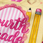 Card with 'fourth grade' text and two pencils on a pink and yellow background