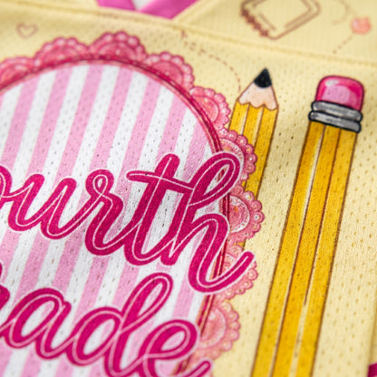 Card with 'fourth grade' text and two pencils on a pink and yellow background