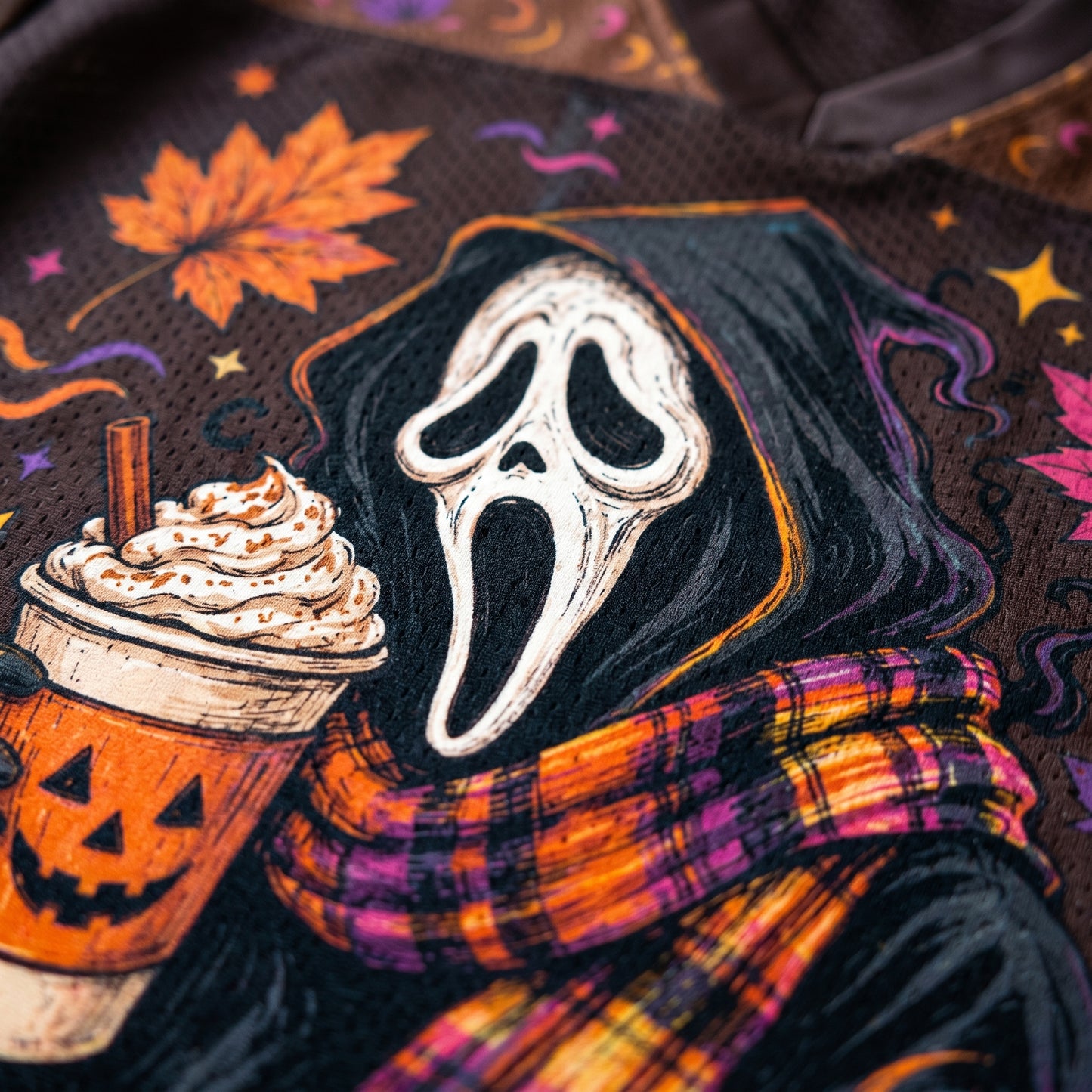 Halloween-themed design with ghost face, pumpkin spice latte, and plaid scarf on a dark background.