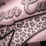 Close-up of a product with leopard print pattern and 'our' text on a pink background