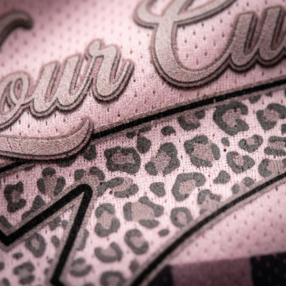 Close-up of a product with leopard print pattern and 'our' text on a pink background