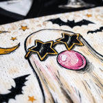Decorative card with ghost, stars, and moon design on a textured background