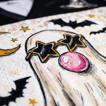 Decorative card with ghost, stars, and moon design on a textured background