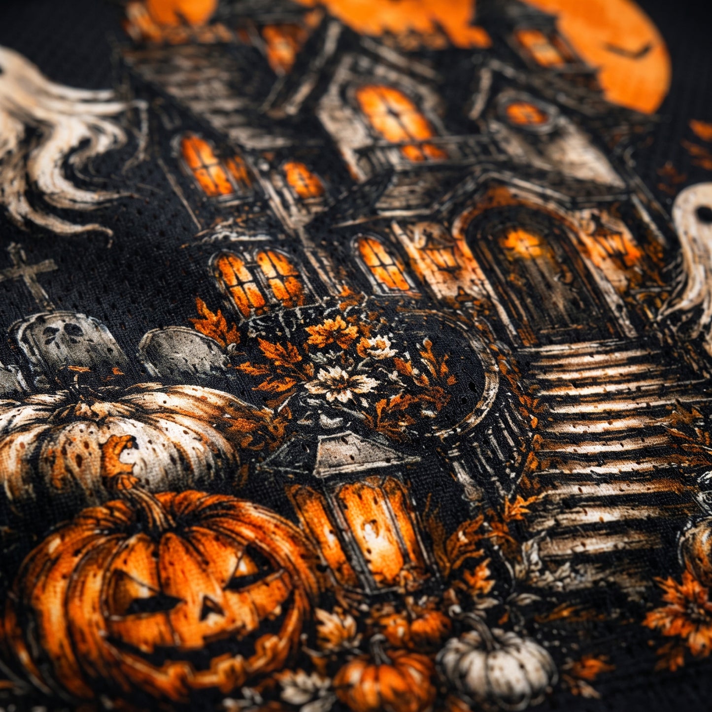 Halloween-themed fabric with pumpkins, ghosts, and a haunted house.