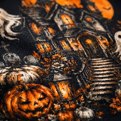 Halloween-themed fabric with pumpkins, ghosts, and a haunted house.