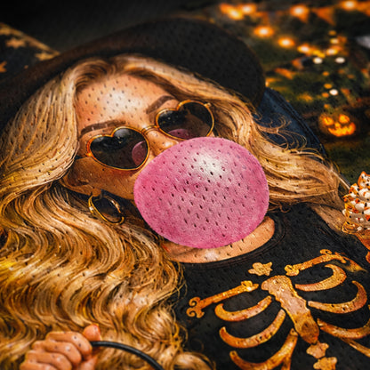 Person wearing a pink textured mask and sunglasses with a skeleton design on clothing.