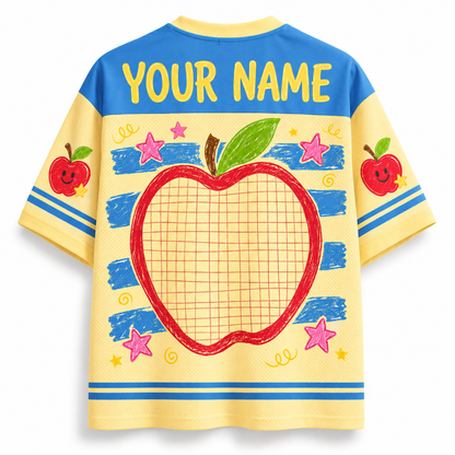 Children's t-shirt with a red apple design and space for 'Your Name' on a yellow and blue background.