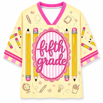 Yellow shirt with 'fifth grade' text and pencil designs on a white background