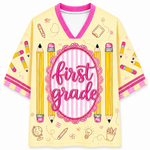 Children's shirt with 'first grade' design featuring pencils and educational symbols on a yellow background.