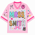 Pink shirt with 'Mrs. Smith' text and various graphics on a white background
