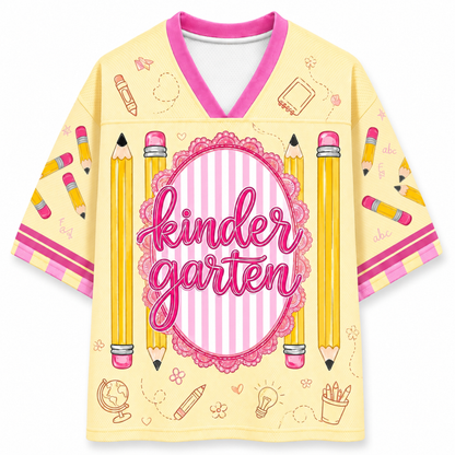 Yellow shirt with pink accents and 'kindergarten' text, featuring pencils and educational symbols on a white background.