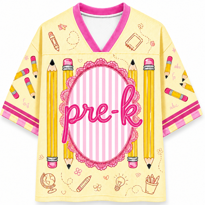 Yellow shirt with pink accents and 'pre-k' text, featuring pencils and educational symbols on a white background.