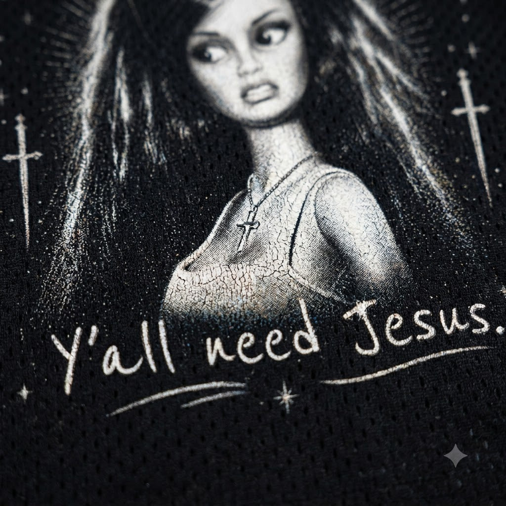 Black mesh athletic shirt featuring a black and white graphic of a woman with long hair, a cross necklace, and the text 'Y'all need Jesus.' with hand-drawn style crosses and stars.