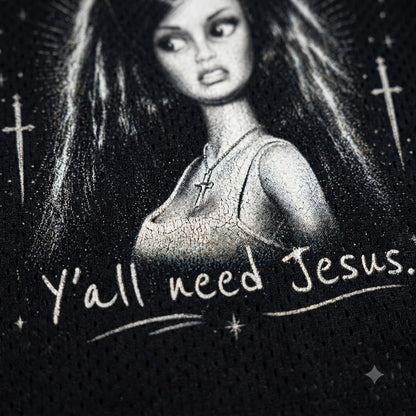 Black mesh athletic shirt featuring a black and white graphic of a woman with long hair, a cross necklace, and the text 'Y'all need Jesus.' with hand-drawn style crosses and stars.