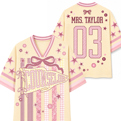 Yellow and pink sports jersey with 'Mrs. Taylor 03' and 'Counselor' text on a white background