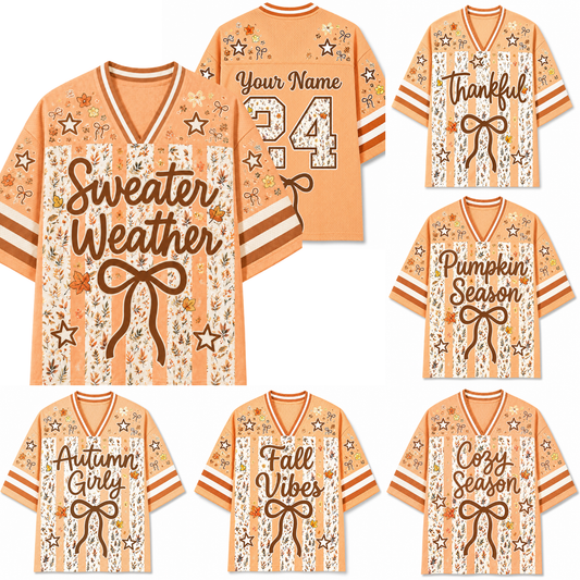A collage of peach and cream striped V-neck jerseys with autumn-themed graphics, including stars, bows, and seasonal phrases like 'Sweater Weather,' 'Thankful Season,' 'Pumpkin Season,' 'Autumn Girl,' 'Fall Vibes,' and 'Cozy Season.'.