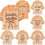 A collage of peach and cream striped V-neck jerseys with autumn-themed graphics, including stars, bows, and seasonal phrases like 'Sweater Weather,' 'Thankful Season,' 'Pumpkin Season,' 'Autumn Girl,' 'Fall Vibes,' and 'Cozy Season.'.