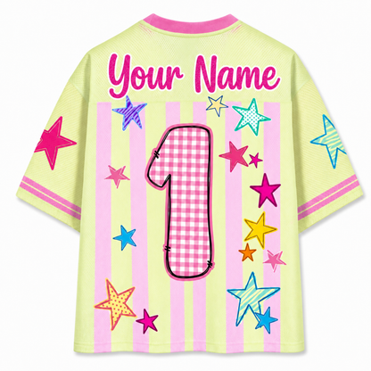Children's shirt with colorful stars and a checkered number on a light green background